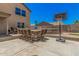 Backyard featuring an outdoor kitchen with bar seating, basketball hoop, and a trampoline at 3016 W White Canyon Rd, San Tan Valley, AZ 85144