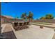 Inviting backyard patio with a dining table set, basketball hoop, and space for trampoline and more at 3016 W White Canyon Rd, San Tan Valley, AZ 85144