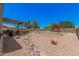 Expansive backyard featuring a playhouse, covered patio, rock garden and more to enjoy the outdoors at 3016 W White Canyon Rd, San Tan Valley, AZ 85144