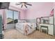 Cozy pink bedroom features a ceiling fan, vanity area, window, and comfortable furnishings at 3016 W White Canyon Rd, San Tan Valley, AZ 85144