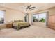 Spacious bedroom with a ceiling fan, ample natural light from large windows, and neutral-toned walls at 3016 W White Canyon Rd, San Tan Valley, AZ 85144