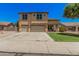 Charming two-story home featuring a large driveway and a well-maintained lawn at 3016 W White Canyon Rd, San Tan Valley, AZ 85144