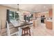 Spacious kitchen and dining area featuring a large island and sliding glass doors to the backyard at 3016 W White Canyon Rd, San Tan Valley, AZ 85144