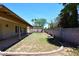 Green backyard with grass, block wall, trees, landscaping, and covered patio at 3033 W Tierra Buena Ln, Phoenix, AZ 85053