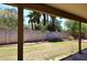 Green backyard with grass, block wall, landscaping, and covered patio at 3033 W Tierra Buena Ln, Phoenix, AZ 85053