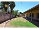 Green backyard with grass, block wall, trees, landscaping, and covered patio at 3033 W Tierra Buena Ln, Phoenix, AZ 85053