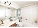 This bathroom has a shower-tub combo and bright vanity lighting at 3033 W Tierra Buena Ln, Phoenix, AZ 85053