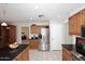 Kitchen with stainless steel appliances, oak cabinets, granite countertops, and tile flooring at 3033 W Tierra Buena Ln, Phoenix, AZ 85053
