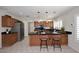 Bright kitchen featuring wood cabinets, stainless appliances, tile floors and granite countertops and seating at 3033 W Tierra Buena Ln, Phoenix, AZ 85053