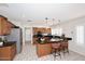 Kitchen featuring tile floors, dark countertops, a center island, and stainless steel appliances at 3033 W Tierra Buena Ln, Phoenix, AZ 85053