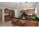 Spacious kitchen with wood cabinets, granite countertops, stainless steel appliances, and a breakfast bar at 3033 W Tierra Buena Ln, Phoenix, AZ 85053