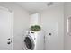 Laundry room equipped with a modern washing machine and built-in overhead storage at 3033 W Tierra Buena Ln, Phoenix, AZ 85053
