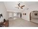 Spacious living room with a high ceiling, ceiling fan, and neutral color palette at 3033 W Tierra Buena Ln, Phoenix, AZ 85053