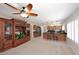 Open concept living space with a large entertainment center, kitchen island, and modern appliances at 3033 W Tierra Buena Ln, Phoenix, AZ 85053