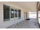 White table and chairs on covered patio near windows and doors to yard at 3033 W Tierra Buena Ln, Phoenix, AZ 85053