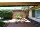 Cozy outdoor patio area, perfect for relaxing with a small table and chairs set among lush greenery at 3033 W Tierra Buena Ln, Phoenix, AZ 85053