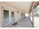 Covered patio with double doors to yard and small table with chairs at 3033 W Tierra Buena Ln, Phoenix, AZ 85053