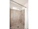 Tiled shower with a curtain, window, silver shower head, and tiled floor at 3033 W Tierra Buena Ln, Phoenix, AZ 85053