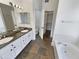 Bathroom with double sinks, a large mirror, and a separate shower and tub at 317 E Nunneley Rd, Gilbert, AZ 85296