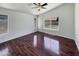 Well-lit bedroom with hardwood floors, a ceiling fan, and view to the backyard at 317 E Nunneley Rd, Gilbert, AZ 85296