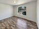 Bright bedroom with hardwood floors and a large arched window for natural light at 317 E Nunneley Rd, Gilbert, AZ 85296