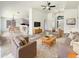 Spacious living room featuring neutral tones, tile flooring, a ceiling fan, and an open floor plan at 317 E Nunneley Rd, Gilbert, AZ 85296