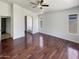Large main bedroom with hardwood floors, neutral walls, a ceiling fan, and an ensuite bathroom at 317 E Nunneley Rd, Gilbert, AZ 85296