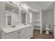 Bright bathroom featuring a double sink vanity with modern fixtures and vinyl plank flooring at 320 E Mckellips Rd # 245, Mesa, AZ 85201