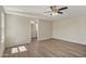Primary bedroom with wood-look floors and neutral walls leads to an en suite bathroom with white vanity at 320 E Mckellips Rd # 245, Mesa, AZ 85201