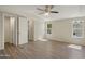 Spacious primary bedroom with wood-look floors featuring bright windows and doorways to other spaces at 320 E Mckellips Rd # 245, Mesa, AZ 85201
