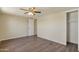 A modest bedroom featuring natural light, a ceiling fan, and wood vinyl flooring at 320 E Mckellips Rd # 245, Mesa, AZ 85201