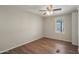 A modest bedroom featuring natural light, a ceiling fan, and wood vinyl flooring at 320 E Mckellips Rd # 245, Mesa, AZ 85201