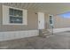 View of the property's entrance featuring a large carport, white door, and small porch with steps at 320 E Mckellips Rd # 245, Mesa, AZ 85201