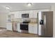 Well-lit kitchen featuring stainless steel appliances, bright white cabinetry, and laminate countertops at 320 E Mckellips Rd # 245, Mesa, AZ 85201