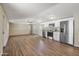 Open living area with wood-look floors adjoining the kitchen, complete with stainless steel appliances at 320 E Mckellips Rd # 245, Mesa, AZ 85201