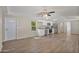 Spacious living area showcasing wood-look flooring, a kitchen with stainless steel appliances, and natural light at 320 E Mckellips Rd # 245, Mesa, AZ 85201