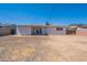Wide shot of backyard featuring a gravel surface, the home's patio, and fences on the side at 3423 W Bloomfield Rd, Phoenix, AZ 85029