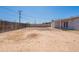 This expansive backyard features a dirt surface, plus a wooden fence and home's patio at 3423 W Bloomfield Rd, Phoenix, AZ 85029