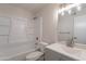 This renovated bathroom offers a shower-tub combo, single sink vanity, and modern fixtures at 3423 W Bloomfield Rd, Phoenix, AZ 85029