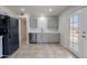 Modern kitchen with stainless steel appliances, gray cabinets, and door to back at 3423 W Bloomfield Rd, Phoenix, AZ 85029