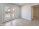 Living room with tiled floors, adjacent to the backyard and neutral paint at 3423 W Bloomfield Rd, Phoenix, AZ 85029