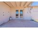 This covered patio features double doors to backyard, plus a door leading to the interior at 3423 W Bloomfield Rd, Phoenix, AZ 85029