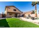 Spacious backyard boasts lush artificial turf, rock accents, and relaxing outdoor living areas at 3619 N 104Th Dr, Avondale, AZ 85392