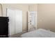 Comfortable bedroom with a modern dresser, a large mirror, and an access door at 3619 N 104Th Dr, Avondale, AZ 85392