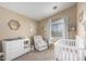 This is a Bedroom that is complete with a crib, accent wall, and changing table at 3619 N 104Th Dr, Avondale, AZ 85392