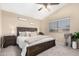 Inviting bedroom with a vaulted ceiling, ceiling fan, and a comfortable king-sized bed at 3619 N 104Th Dr, Avondale, AZ 85392