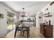 Open kitchen and dining area with sliding door, perfect for modern living and entertaining at 3619 N 104Th Dr, Avondale, AZ 85392