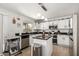 Well-lit kitchen with white cabinets, stainless appliances, and an island at 3619 N 104Th Dr, Avondale, AZ 85392
