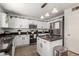 Bright and airy kitchen with stainless steel appliances, stone countertops, and white cabinetry at 3619 N 104Th Dr, Avondale, AZ 85392