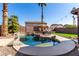Sparkling pool surrounded by mature landscaping creates a private backyard retreat for relaxing or entertaining at 3619 N 104Th Dr, Avondale, AZ 85392